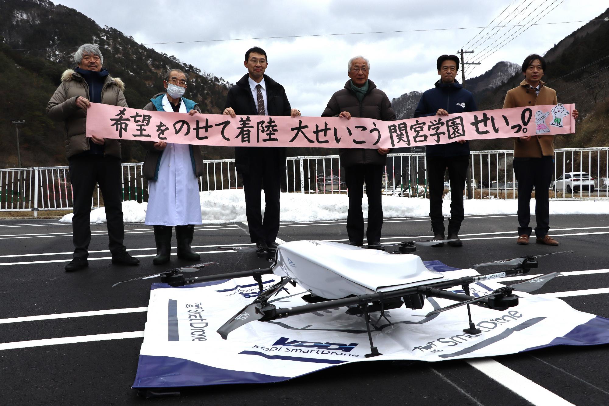 関宮学園からの届け物を広げる関係者ら
